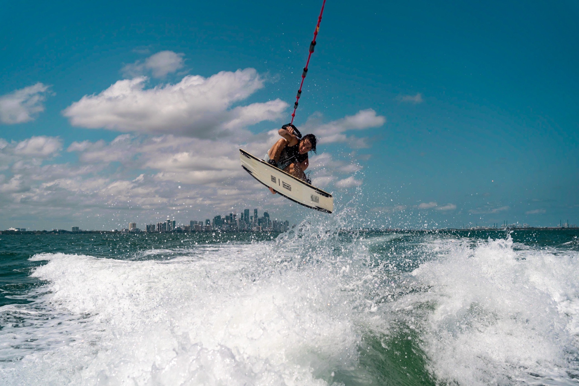 Wakeboarder jumping over Miami water