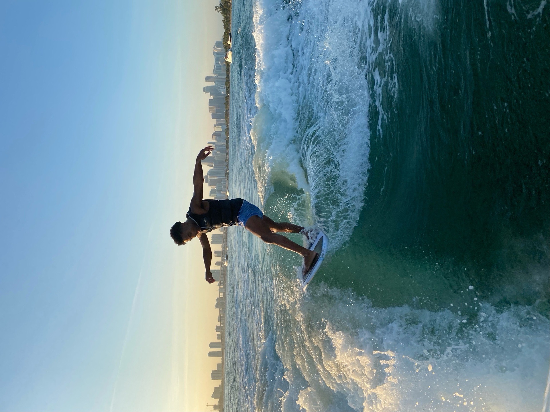 Wakesurfing at golden hour during a WakeXscape sunset charter