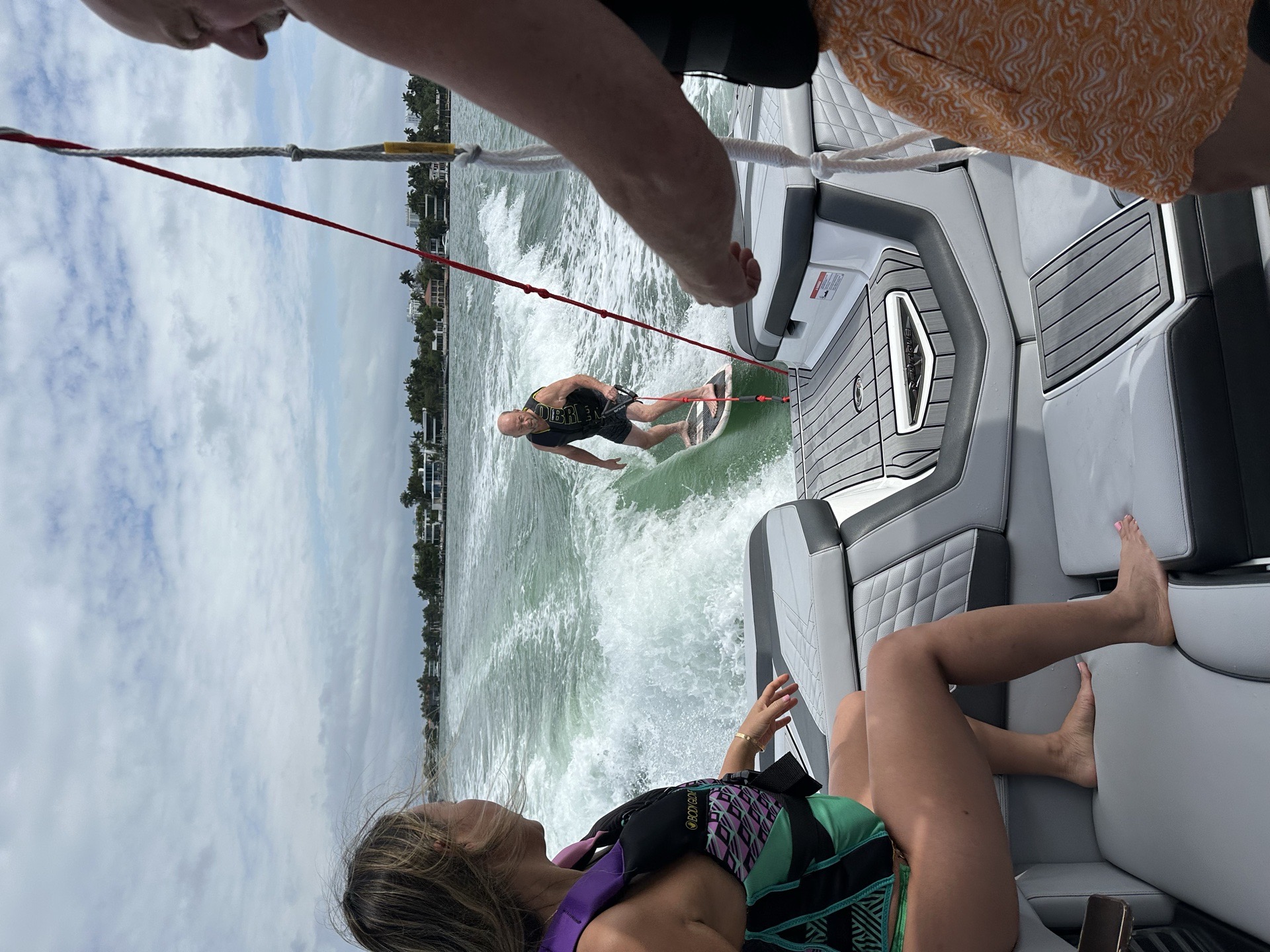 Coach and rider discussing a wakesurf pass aboard the boat
