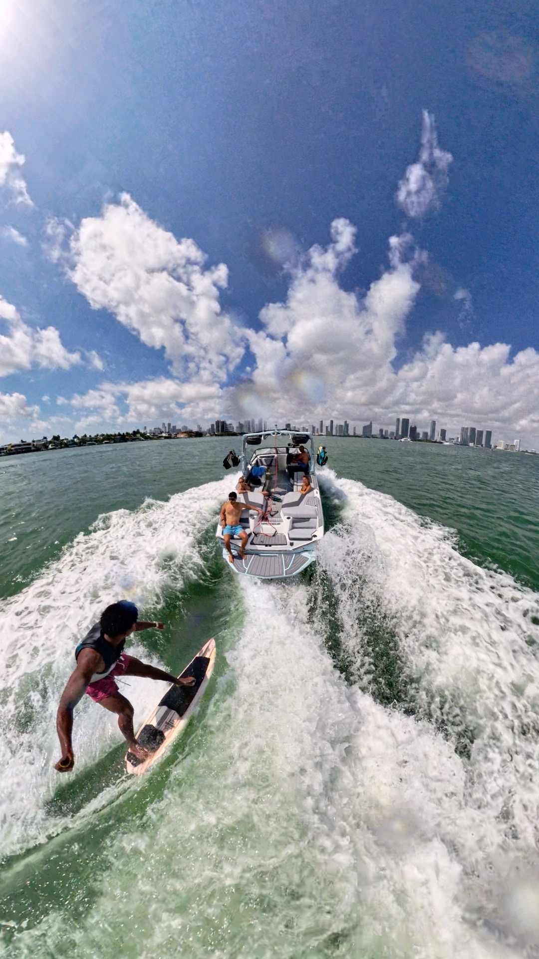 Rope-free wakesurfer riding behind the boat